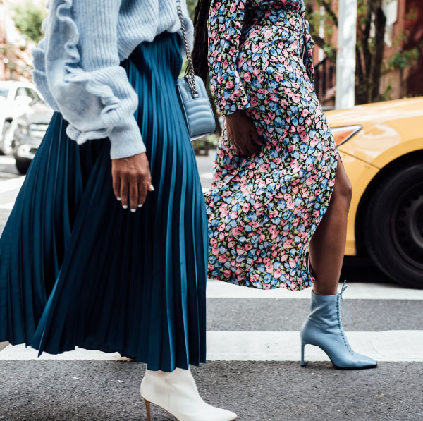 Two people walking across an urban street